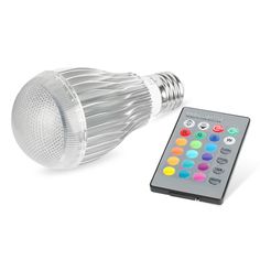 the remote control is next to an led light bulb with multicolored lights on it