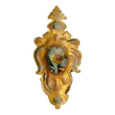 an ornately carved gold wall mounted sculpture