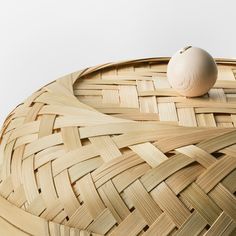 an egg sitting on top of a woven basket