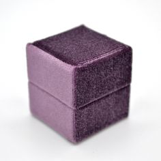 a small purple box sitting on top of a white table