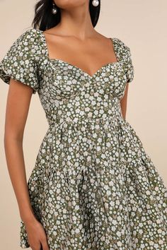 Let your adorable style speak for you with the Lulus Confident Sweetheart Olive Floral Jacquard Tiered Mini Dress! Lightweight woven jacquard forms a darling floral design as it shapes short puff sleeves with elastic at the cuffs and shoulders. Sweetheart neckline tops seamed cups and a bodice with a flattering set-in waist. Tiered skirt falls to a cute mini hem. Smocked panel at back for fit. Hidden side zipper. Fit: This garment fits true to size. Length: Mid-thigh. Size medium measures 25.5" Lined Short Sleeve Mini Dress For Garden Party, Lined Mini Dress With Short Sleeves For Garden Party, Floral Print Fit And Flare Mini Dress, Fitted Dress With Ditsy Floral Print And Sweetheart Neckline, Flirty A-line Mini Dress With Floral Print, Fitted Floral Print A-line Mini Dress, Fitted Printed Mini Dress For Garden Party, Flirty Cotton Mini Dress With Floral Print, Fitted Floral Dress With Ditsy Print And Square Neck