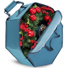 a blue bag with red berries and greenery in it is opened to show the inside