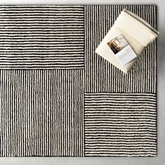 a black and white striped rug with an open book