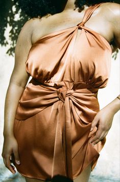 Plus-size, tie front satin mini dress in rust with keyhole at front and draped front skirt overlay. Comes in Sizes 12-24. Made for your curves. Pre-draped Halter Neck Party Maxi Dress, Pre-draped Halter Evening Dress, Pre-draped Halter Neck Cocktail Dress, Draped Halter Dress For Cocktail, Flirty Draped Dress For Date Night, Flirty Draped Dress For Night Out, Fitted Draped Halter Dress For Cocktail, Fitted Draped Halter Dress For Cocktail Events, Night Out Mini Dress With Pre-draped Style