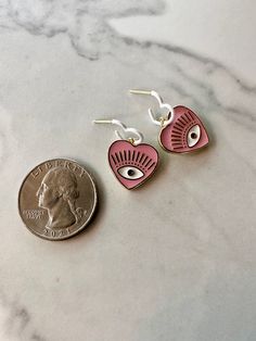 this listing is for one pair of hypoallergenic dainty dangle earrings. The posts are sterling silver. Enamel hearts and evil eye charms make up these lovely earrings. Pink Evil Eye, Dainty Dangle Earrings, Heart Dangle Earrings, Evil Eye Charm, Lovely Earrings, Silver Enamel, Evil Eye, Dangle Earrings, Make Up