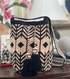 -Large Crossbody Wayuu Handbag,wayuu  bag, bohemian style, ethnic pattern -Original handmade Wayuu mochila bag that will go with any outfit. -The stunning, one-of-a-kind, 100% handmade crossbody has been carefully crocheted.  You can adjust the strap with a knotting it. This is an unique high-quality crochet bag which contain a beautiful color combination and tribal patterns  -This beautiful Wayuu bag that was carefully crafted using a single thread technique, which is the most traditional croch Bohemian Beige Backpack, Bohemian Pouch Bucket Bag For Daily Use, Bohemian Bucket Bag With Weaving For Everyday Use, Bohemian Satchel Bucket Bag For Festivals, Bohemian Crossbody Bucket Bag For Festivals, Bohemian Weave Bucket Bag For Everyday Use, Bohemian Bucket Shoulder Bag For Travel, Bohemian Rectangular Bucket Bag With Adjustable Strap, Bohemian Festival Crossbody Bucket Bag