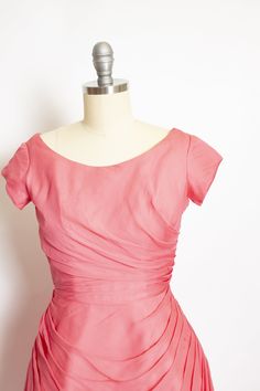 "Gorgeous vintage late 50s - early 60s party dress. Medium pink chiffon is beautifully pleated from the side seams of skirt, around rounded seam at seat and from side waist. Darted bust cap sleeve top with wide scoop neck. Hidden back metal zipper. Skirt is backed with a still inset to add volume in a bell shape - bodice lined in cotton. Label: Erlenbaches DC Fits like size: Extra Small - See measurements to be sure. Measurements: Bust: 34\" Waist: 23.5-firm 24\" Hip: free Length: 37 Condition: Vintage Fitted Dress With Ruched Bodice, Fitted Vintage Dress With Ruched Bodice, Pink Formal Dress With Pleated Waist, Vintage Ruched Dress For Garden Party, Pink Pleated Back Dress For Wedding, Pink Evening Dress With Pleated Waist, Pink Pleated Back Wedding Dress, Evening Pink Dresses With Pleated Waist, Vintage Fitted Ruched Dress