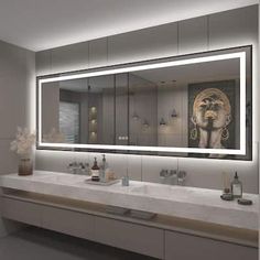 a bathroom with two sinks and a large mirror over it's counter top area