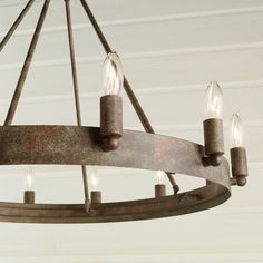 a chandelier with five candles hanging from it's center ring and four lights on each end