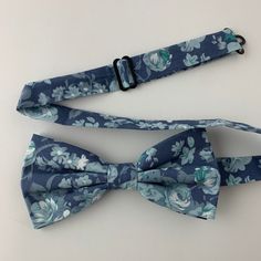 This handmade floral tie is an excellent accessory for weddings, parties, proms - an excellent gift for anyone who enjoys dressing-up dapper! Style: Slim/narrow Fabric: 100% cotton Approx. Measurements: (W) 2.4 in. x (L) 58 in. Care: Dry clean only Matching Men's Bow Tie Style: Pre-tied (w/ adjustable straps) Fabric: 100% brushed cotton Size: Mens | One size Bow measures approx. 4.75 in. x 2.4 in. Care: Dry clean only Matching Pocket Square Fabric: 100% brushed cotton Approx. 12 in. x 12 in. Dry Square Fabric, Groomsman Gift, Dapper Style, Tie Styles, Mens Bow Ties, Party Style, Blue Floral Print, Fabric Squares, Brushed Cotton