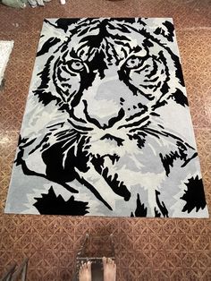 a rug with a tiger on it in the middle of someone's legs and feet