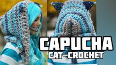 a woman with blue hair wearing a crochet hat and cat ears on her head