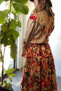 Vintage Diane Freis Gold, Caramel and Red Skirt Set in wonderful condition. Sparkly fall dream set! Big flowy skirt has an all over floral pattern and a nice stretch at the waistband. The long sleeve flouncy v neck top is adorned with a matching floral pattern. You really feel like a fairy in this one! 100% Silk. Dry clean only. Made in Hong Kong. Fits M-L best. Approx. Measurements: Sweater: Underarm to Underarm: 19" Length: 19" Skirt: Waist: 26"-40" - elastic Length: 34" Red Floral Print Skirt For Fall, Fall Bohemian Skirt With Floral Print, Bohemian Floral Print Fall Skirt, Fall Bohemian Floral Print Skirt, Bohemian Red Skirt For Fall, Multicolor Skirt With Elastic Waistband For Fall, Fall Multicolor Skirt With Elastic Waistband, Fall Bohemian Skirt With Elastic Waistband, Bohemian Fall Skirt With Elastic Waistband