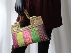 Indian vintage design handbag- bride's stone, beads and sequins bag: Take rich raw silk with different colors and designs. Add strips of red gold zari borders between to contrast one from the other. Add some more rhinestones, sequin and embroidery work. Add handles made of more beads.....youve got a classy dress purse Multicolor Evening Bags With Handwork, Evening Multicolor Bags With Handwork, Multicolor Handwork Evening Bags, Multicolor Evening Bags For Festivals, Multicolor Handmade Evening Bag For Festivals, Handmade Multicolor Evening Bag For Festivals, Elegant Multicolor Potli Bag For Party, Rectangular Multicolor Potli Bag For Evening, Traditional Embellished Rectangular Potli Bag