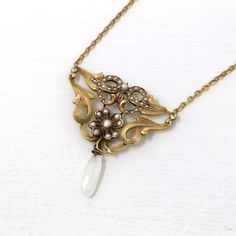 Gorgeous antique circa 1900s era Art Nouveau 10k yellow gold lavalier necklace! This stunning pendant has gorgeous swirling designs and a four leaf clover motif, accented with seed pearls. There is a decorative baroque pearl dangling from the bottom of the piece. A fantastic piece of fine antique jewelry, featuring June's birthstone!  ERA - Circa 1900s - Art Nouveau  METAL / MATERIAL - 10k yellow gold pendant and chain, seed pearls MARKINGS / HISTORY - Back of pendant is stamped 10k CONDITION - Good antique condition. Yellow gold metal has been professionally polished & cleaned. Age appropriate patina & wear remains. Amazing antique necklace!  SIZE / MEASUREMENTS - Length: 14 1/2 inches, Pendant length: 1.5 inches, Total Weight: 4.28 grams PRESENTATION - Listing includes a complimentary MJ Victorian Baroque Yellow Gold Jewelry, Victorian Jewelry With Historical Design For Evening, Heirloom Necklace With Intricate Design For Formal Occasions, Formal Heirloom Necklace With Intricate Design, Antique Baroque Jewelry For Wedding, Ornate Historical Design Necklaces For Formal Occasions, Vintage Baroque Jewelry For Formal Occasions, Ornate Historical Design Necklace For Formal Occasions, Antique Yellow Gold Necklace With Historical Design