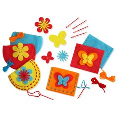 felt craft kit with flowers, butterflies and scissors on a white background for kids to make