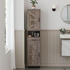 a white sink sitting next to a wooden cabinet