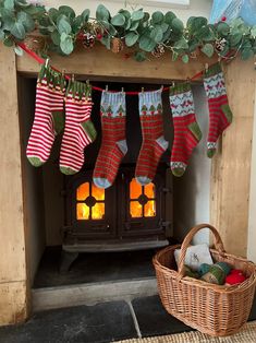 stockings hanging from a fireplace with candles in the background