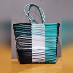 New, Never Used, Artisanal Handmade Platic Woven Tote, No Pockets, Color Teal, White And Black, Great Big Tote For The Beach And Shopping, Easy To Clean, Measurements As Shown In Pictures. Black Handmade Rectangular Bag, Black Handmade Rectangular Shoulder Bag, Handmade Black Satchel For Shopping, Handwoven Black Rectangular Beach Bag, Black Handwoven Beach Bag For Daily Use, Artisan Black Shoulder Bag, Black Handmade Rectangular Beach Bag, Handmade Black Rectangular Beach Bag, Black Handmade Handheld Satchel