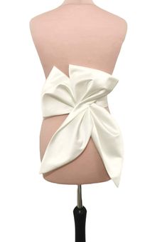 This big fashion bow is made from ivory Duchess satin and can be perfect choice for your glamour bridal look. The length of the bow is about 50cm. Our bow can be ordered separate or with belt. Can be made in soft matte satin, duchess satin or Mikado fabric. ALL OF OUR PRODUCTS ARE HANDMADE BY US AND MADE WITH THE BEST HIGH-QUALITY FABRICS. If you have any questions about our products do not hesitate to contact us! SAMPLES(SWATCHES) LOWER COST SHIPPING, FOR CUSTOMER FROM OUTSIDE THE UK PLEASE USE THIS LINK FOR SAMPLES(SWATCHES): https://www.etsy.com/uk/listing/949775560/fabrics-samples-swatches-glitter-tulle?ref=listings_manager_grid *DELIVERY We use standard delivery service for the UK with Royal Mail 1st class service which normally takes 1-2 working days without tracking. For internation Dress With Bow Belt, Bow Belt Dress, Chic Evening Bow With Detachable Feature, White Fitted Dress With Detachable Bow, Classic Detachable Bow, Luxury Satin Bow Tie Back Bow, White Detachable Bow For Evening, Chic Mini Wedding Dress With Detachable Bow, Wedding Dress Bow