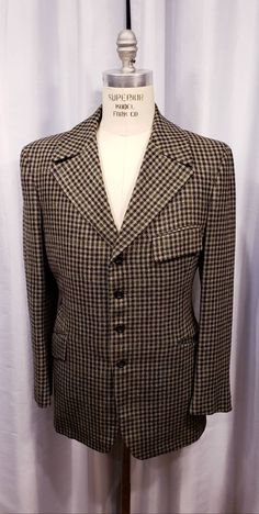 Beautiful houndstooth cloth two piece suit probably made in the 70's but exceptional quality. With the proper accessories it would be hard to tell this is not a true period piece, but the next best thing. Ready for the Dickens Faire or a period holiday party. Inside label reads: Mike Bain Inside pocket still has the Amalgamated Union Tag made in the USA the United States of America. Coat measures: Shoulders 18 1/2 inches, Chest 45 inches, sleeves 25 inches and length is 31 inches. Pants measure: Fitted Vintage Outerwear With Houndstooth Pattern, Vintage Fitted Houndstooth Blazer, Fitted Vintage Houndstooth Blazer, Retro Formal Tweed Blazer, Vintage Formal Tweed Jacket With Houndstooth Pattern, Vintage Tweed Jacket With Houndstooth Pattern For Formal Occasions, Vintage Houndstooth Tweed Jacket For Business, Vintage Houndstooth Tweed Jacket For Formal Occasions, Vintage Houndstooth Notch Lapel Blazer