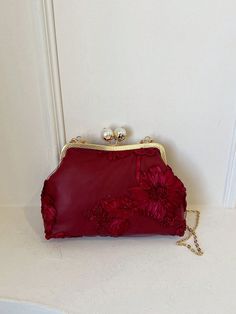 Expertly crafted for special occasions, our Romantic Wine Red 3D Flower Handbag is adorned with faux pearls for a touch of elegance. The intricate 3D flower design adds romantic charm to any outfit. Ideal for formal events or date nights, this handbag is the perfect accessory for a polished and sophisticated look. Color : Burgundy Bag Size : Medium Pattern Type : Plants Type : Kiss Lock Bag Material : Fabric Composition : 100% Polyester Bag Height Bag Length Bag Width 17 30 9 Elegant Flower-shaped Evening Bag, Chic Flower-shaped Evening Bag For Formal Occasions, Chic Floral Evening Bag For Formal Events, Elegant Flower Shaped Clutch For Formal Occasions, Elegant Flower Shaped Evening Bag For Gifts, Elegant Flower-shaped Evening Bag For Gifts, Elegant Flower Shaped Evening Bag For Events, Chic Burgundy Clutch For Party, Elegant Flower-shaped Evening Bag For Events