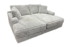 a couch that is made out of some kind of fabric with pillows on top of it