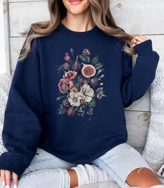 Fig Fruit Vintage Sweatshirt, Figs Floral Crewneck Pullover, Cute Womens Shirt, Retro Boho Fruit, Aesthetic Flower Sweater, Gift For Her A sturdy and warm sweatshirt bound to keep you warm in the colder months. A pre-shrunk, classic fit sweater that's made with air-jet spun yarn for a soft feel. * 50% cotton, 50% polyester * Pre-shrunk * Classic fit * 1x1 athletic rib knit collar with spandex * Air-jet spun yarn with a soft feel * Double-needle stitched collar, shoulders, armholes, cuffs, and hem Printed Relaxed Fit Sweatshirt For Fall, Fall Floral Print Crew Neck Sweater, Floral Print Crew Neck Sweater For Fall, Winter Floral Print Cotton Tops, Casual Long Sleeve Tops With Plant Print, Cotton Floral Print Long Sleeve Sweater, Fall Cotton Sweater With Floral Print, Fall Cotton Floral Print Sweater, Cotton Floral Print Fall Sweater