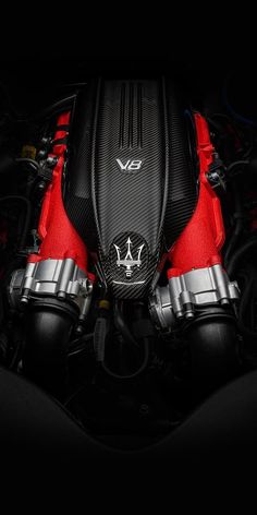 the engine compartment of a sports car with red and black trims on it's hood