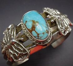 "VINTAGE NAVAJO BRACELET DESCRIPTION: This spectacular cuff features a lovely specimen of brilliant blue turquoise, flanked by a pair of tufa cast butterflies. The gemstone and the butterflies rest on a super heavy gauge, triple carinated cuff bracelet. This lovely bracelet will be a cherished addition to your collection of fine vintage Native American jewelry. MEASUREMENTS: Interior of the cuff measures 5 1/4\" with an additional 1 1/4\" non-adjustable gap. Total circumference: 6 1/2\" Measures Butterflies Jewelry, Silversmith Jewellery, Native American Jewelry Navajo, Bones Bracelet, Vintage Native American Jewelry, Navajo Bracelet, Navajo Jewelry, Turquoise Bracelet Cuff, Handcrafted Bracelets