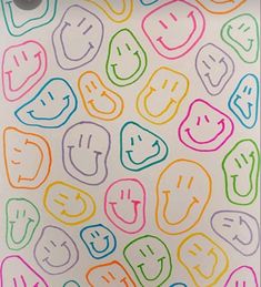 an image of colorful smiley face stickers on white paper with multicolored lines