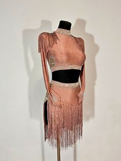 a mannequin wearing a pink dress with fringes on it