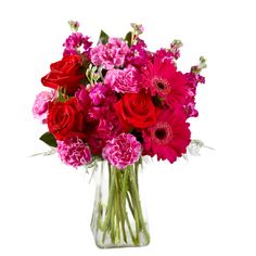 a vase filled with red and pink flowers