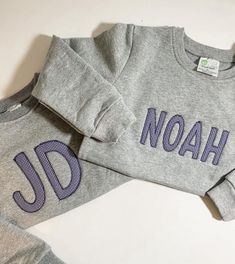 "This will be your \"go-to\" sweatshirt for your little one!  These sweatshirts scream COMOFORT! They are super soft and warm inside.  These sweatshirts are grey and feature an appliqué name with light navy gingham fabric.  PLEASE NOTE - fabric can be changed to a different color gingham or solid color! You must request this in the personalization box. Please select sweatshirt size. IN PERSONALIZATION BOX - Please type name you would like embroidered.   Please message me with any questions. I am Winter Long Sleeve Sweatshirt With Name Print, Gray Long Sleeve Sweatshirt With Letter Embroidery, Winter Crew Neck Sweatshirt With Name Print, Embroidered Name Sweatshirt, Spring Sweatshirt, Name Sweatshirt, Applique Sweatshirt, Navy Gingham, Embroidered Name