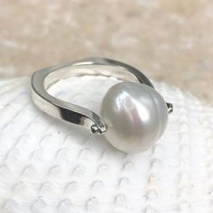 14KT white gold + genuine Paspaley South Sea Pearl Ring. Fashion quality Paspaley pearl. Paspaley Pearls are considered to be the finest South Sea pearls available. Sizing can be customized for an additional charge. Features a modern, European shank band which levels out the ring so there is no slipping and sliding aro Modern Pearl Ring For Formal Occasions, Modern Round Pearl Rings, Modern White Pearl Ring, Modern White Gold Pearl Ring For Anniversary, Modern White Pearl Ring For Anniversary, Modern White Gold Pearl Ring With Polished Finish, Modern White Gold Sterling Silver Pearl Ring, Modern White Pearl Ring With Polished Finish, Modern Silver Pearl Ring