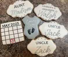 decorated cookies with names and date on them for an upcoming baby's arrival ceremony