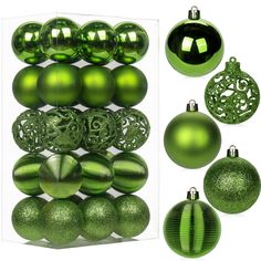 green christmas ornaments are displayed in an open box and on top of another set of balls