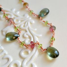 "This item is made to order, and the lead time for this listing is approx. 2-3 weeks from the date of purchase. Please contact me prior to purchase if you have any questions or concerns about the estimated shipping date. This Spring wedding necklace pairs rich blue-green, soft pink and lime green for a decidedly Spring feel. Speckled moss aquamarine, bright peridot and pink/green watermelon tourmaline combine in this lovely necklace, which is ideal for an elegant Spring wedding. Lightweight, ros Briolette Tourmaline Jewelry With Natural Stones, Tourmaline Briolette Jewelry With Natural Stones, Wire Wrapped Tourmaline Jewelry For Jewelry Making, Green Artisan Jewelry For Wedding, Artisan Green Wedding Jewelry, Artisan Green Jewelry For Wedding, Unique Green Tourmaline Jewelry, Green Tourmaline Gemstone Jewelry, Tourmaline Jewelry With Gemstone Accents