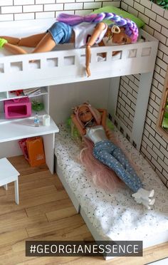 there is a doll laying on top of a bunk bed