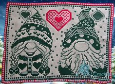 a close up of a piece of cloth with two people on it and a heart in the middle