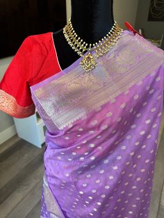 This is a light weight, handwoven semi georgette Banaras saree with gorgeous silver zari border and small bhuttis. This soothing lavender shade saree comes with a contrast red blouse. The saree can be easily draped and is very classy. Blouse is fully stitched and is open with hooks and dori at the back. Blouse is size adjustable from 36-44 inches (with margins inside) Falls/pico are already done and saree is ready to wear. Size 36-44 adjustable stitched blouse : Banaras semi georgette saree silver zari  | gajji silk sarees online shopping us | silver zari saree Contrast Blouse For Silver Saree, Lavender Saree Contrast Blouse, Silver Zari Saree, Zari Saree, Banaras Sarees, Silk Sarees Online Shopping, Red Blouse, Contrast Blouse, Georgette Saree