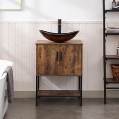 a bathroom sink sitting on top of a wooden cabinet