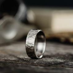 a silver ring sitting on top of a wooden table