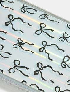 scissors are drawn on the side of a clear plastic case with black lines and bows