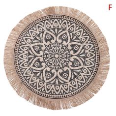 a black and white round rug with fringes on the bottom, in front of a white background