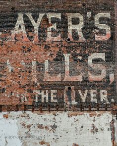 an old sign on the side of a building that says ayer's lils in the liverle