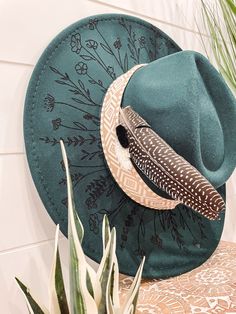 Wildflower Floral Burned Hat, Floral Engraved Cowboy Hat, Sunflower Hat, Sunflower Burned Fedora, Engraved Fedora, Engraved Felt Hat, Boho Hat Elevate your style with our beautifully engraved floral hats! If you want certain colors for the feather/flower detail, please leave a note at checkout. Bands and florals/feathers may shift or fall off during shipping. The hat has an adjustable band on the inside to fit many sizes. One size fits most adult heads. Green Bohemian Hat Bands For Spring, Adjustable Green Felt Hat For Beach, Green Bohemian Fedora, Bohemian Green Fedora Sun Hat, Green Bohemian Fedora Sun Hat, Green Bohemian Hat, Green Brimmed Felt Hat For Festival, Green Wide Brim Felt Hat For Festival, Bohemian Green Fedora Felt Hat