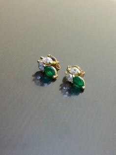 DeKara Designs CollectionMetal- 14K Yellow Gold, .583Stones- 2 Marquise Shaped Colombian Emeralds 0.48 Carats, 4 Marquise Diamonds G Color VS2 Clarity 0.38 Carats.    Measurement- .44 Inches Long, .21 Inches Wide.Handmade 14K Yellow Gold Diamond Emerald Diamond Earrings.  Each piece is handmade, individually set and put together.  The earrings feature two beautiful marquise diamonds on top with a marquise emerald on the bottom.  All the stones are expertly prong set.  The backing of the earrings Fine Jewelry Green Cluster Earrings For Anniversary, Multi-stone Emerald Earrings For Gift, Emerald Multi-stone Earrings For Gift, Green Emerald Multi-stone Earrings, Green Multi-stone Earrings For Anniversary, Emerald Cut Diamond Earrings, Gold Emerald Earrings, Daily Earrings, Vintage Style Wedding Rings