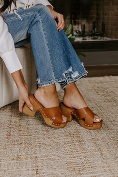 The perfect summer shoe just dropped! Our boho 'Mellow' heel features two wide brown faux leather crossed over-the-foot straps, a rounded open toe, a platform sole with a block heel, and a chunky slip-on silhouette! - This heel runs more true to size. - Heel Height: 3.5 inches Trendy Brown Open Toe Mules, Brown Chunky Platform Open Toe Sandals, Spring Clogs With Wrapped Heel And Round Toe, Casual Brown Sandals With Chunky Platform, Casual Brown Chunky Platform Sandals, Trendy Brown Chunky Platform Sandals, Brown Chunky Platform Wedge Sandals With Round Toe, Brown Wedge Sandals With Chunky Platform And Round Toe, Brown Wedge Sandals With Platform Block Heel