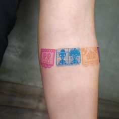 a person with tattoos on their legs has four different colored squares in the shape of playing cards